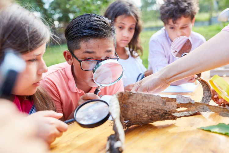 Children exploring nature with tactile science learning activities