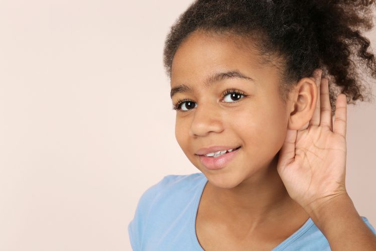 Kid cupping hand around ear to listen closely - auditory learner trait