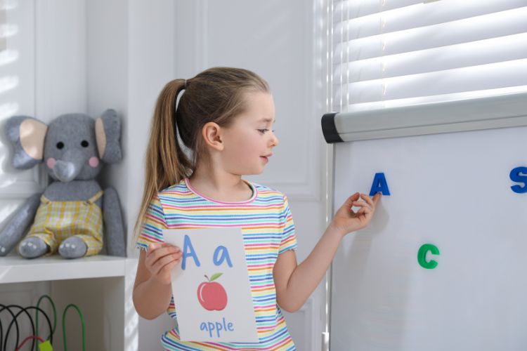 Tactile learner - colorful magnetic letters on a whiteboard