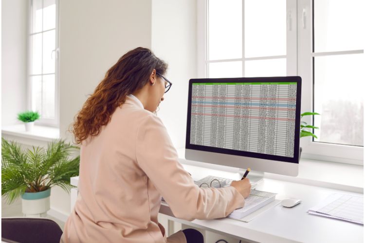 Student analyzing data charts on a computer screen.